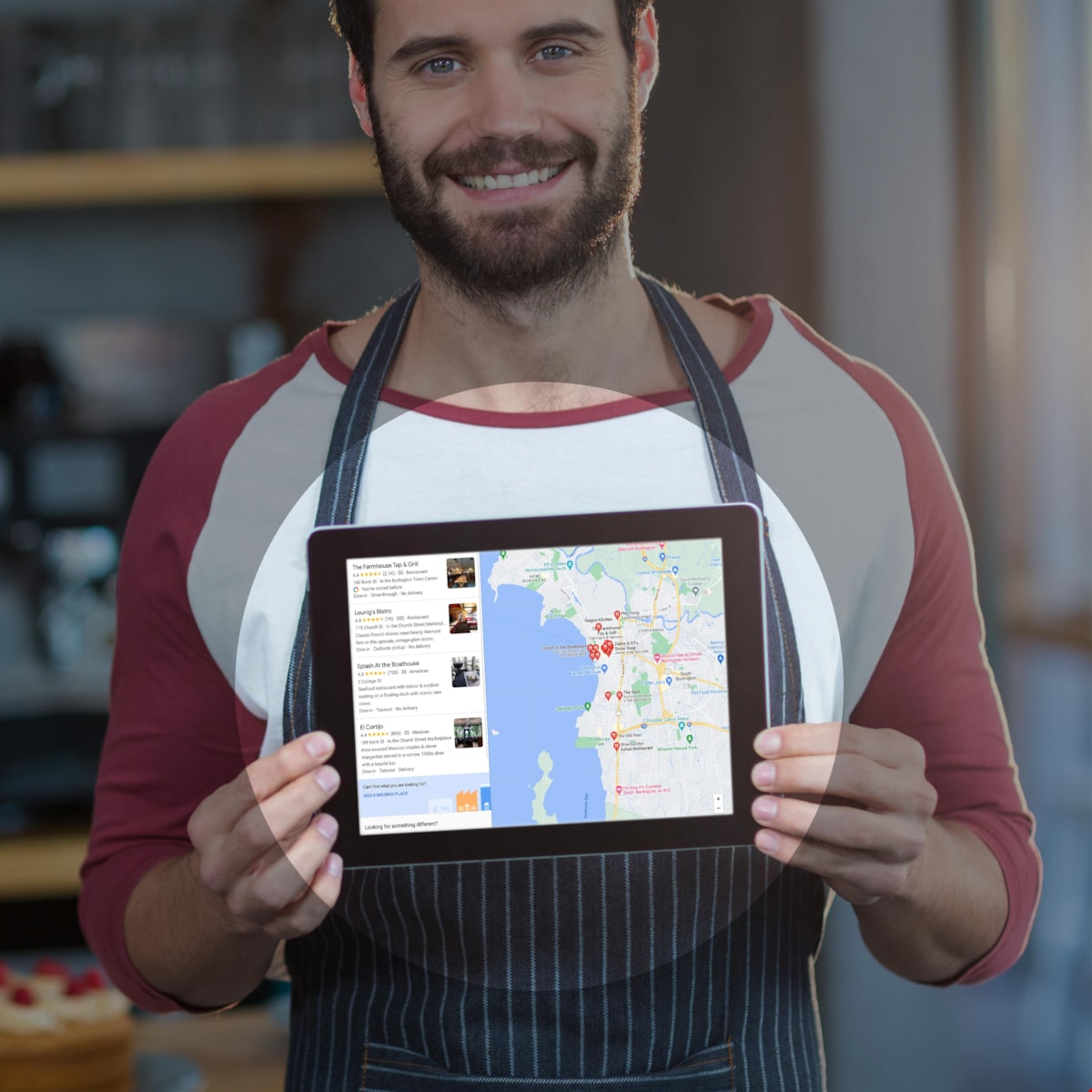 man holding a tablet showing search results for restaurants